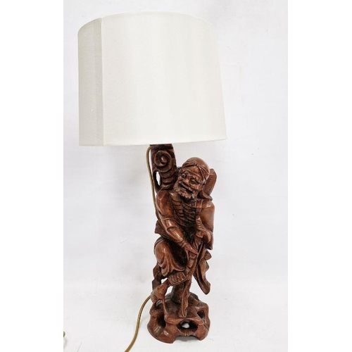 142 - Chinese carved hardwood figural lamp base, 20th century, formed as a man holding on staff, on pierce... 