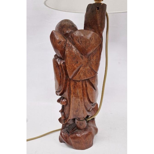 142 - Chinese carved hardwood figural lamp base, 20th century, formed as a man holding on staff, on pierce... 