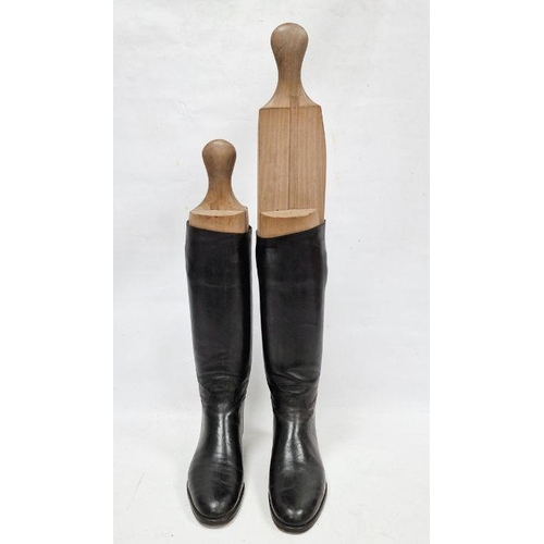 143 - Pair of black leather riding boots with wooden trees, stamped 8 1/2 D / 3532 7, the trees incised L ... 