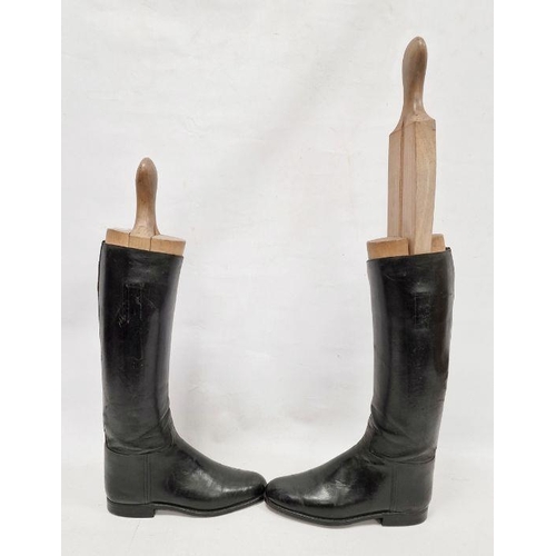 143 - Pair of black leather riding boots with wooden trees, stamped 8 1/2 D / 3532 7, the trees incised L ... 