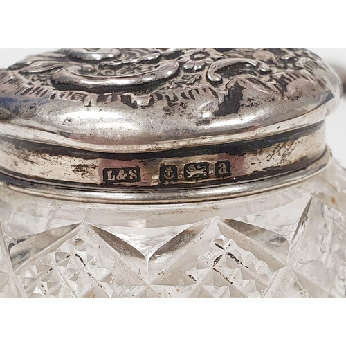 263 - Early 20th century silver-lidded cut glass dressing table pot with repousse decoration, Birmingham 1... 