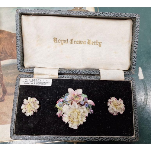 5 - Royal Crown Derby porcelain flower-encrusted brooch and clip-on earrings in original leather case to... 