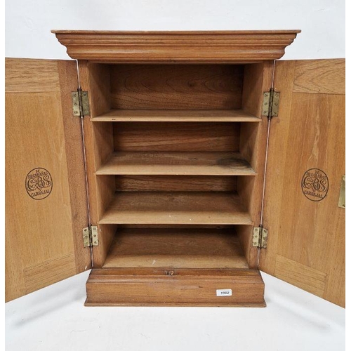 1002 - Mid-century oak cigar cabinet by Decabans, Carbajal, the two doors opening to reveal three fitted sh... 