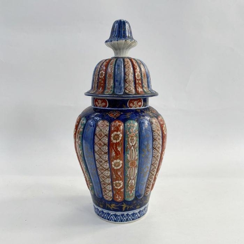 102 - Japanese Imari ribbed porcelain vase, inverse baluster shape and the high domed cover, 40cm high