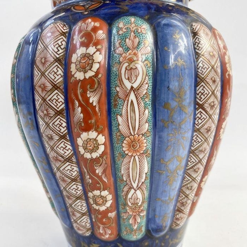 102 - Japanese Imari ribbed porcelain vase, inverse baluster shape and the high domed cover, 40cm high