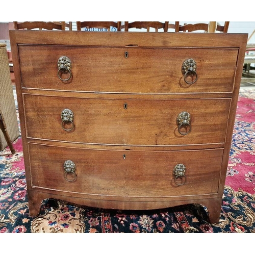 1054 - Late 19th/early 20th century bowfront mahogany chest of drawers having three long drawers, each with... 