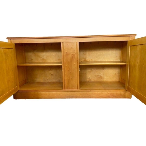 1182 - Modern lightwood, possibly maple, sideboard having moulded edge, two cupboards enclosed by framed pa... 