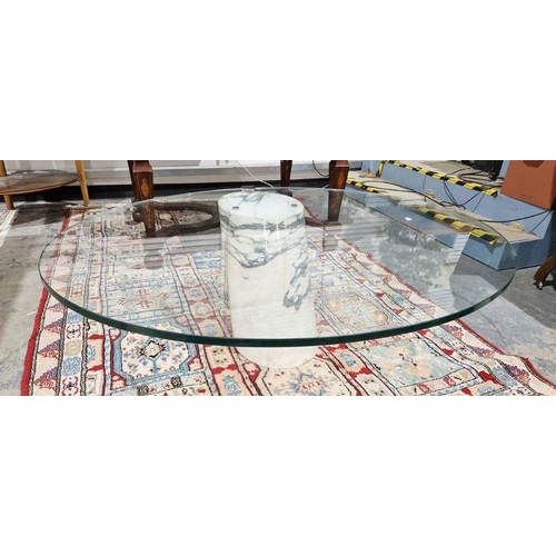 1241 - Contemporary glass-topped coffee table of oval form, raised on large single piece of cylindrical mar... 