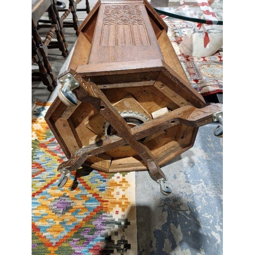 1243 - Early 20th century carved oak revolving bookcase of octagonal form, the four-side panels adourned wi... 