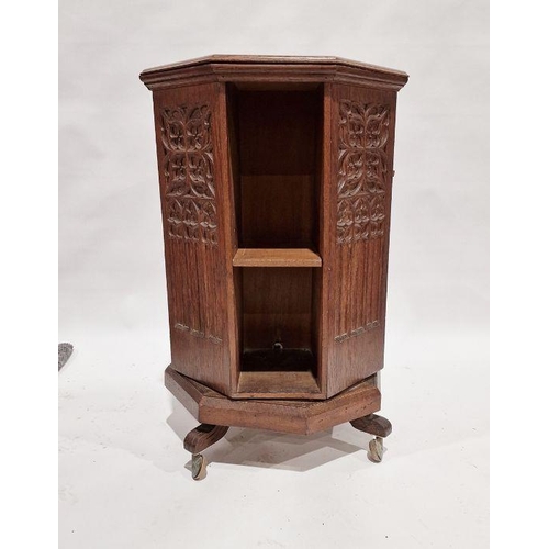 1243 - Early 20th century carved oak revolving bookcase of octagonal form, the four-side panels adourned wi... 