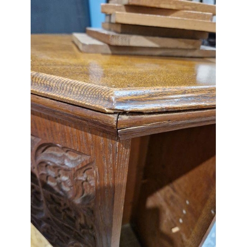 1243 - Early 20th century carved oak revolving bookcase of octagonal form, the four-side panels adourned wi... 