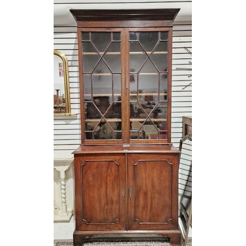 1260 - Mahogany library bookcase, the top glazed section with four adjustable shelves, the base with two do... 