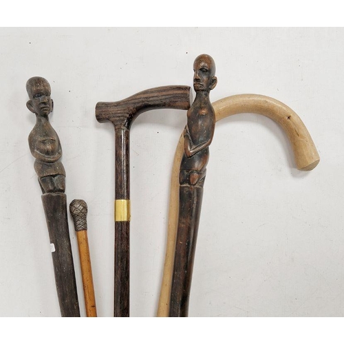 182 - Rosewood-effect walking stick with gilt metal collar, two African carved figure walking sticks, anot... 