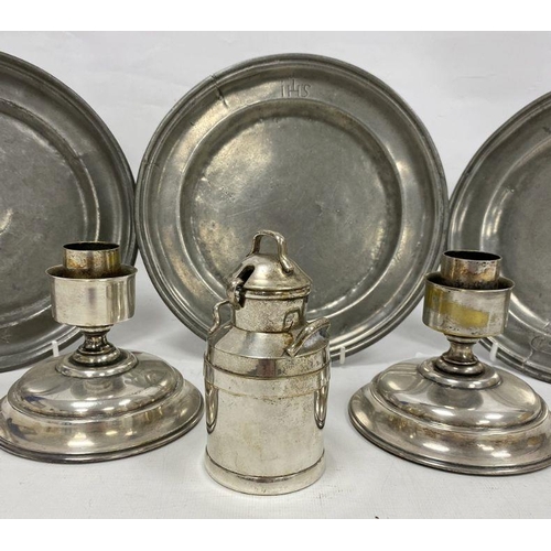 227 - Three pewter plates, a pair of candlestick holders and a sauce pot in the form of a milk churn (1 bo... 