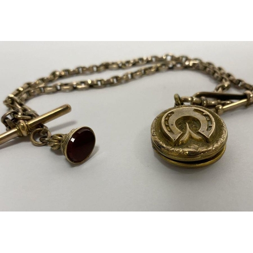 236 - Gold-coloured oval locket pendant, horseshoe embossed with unmarked chain, bar and cornelian set fob... 