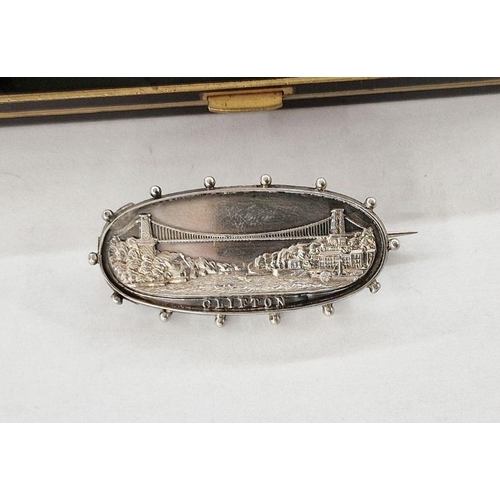 252 - Silver Clifton Suspension Bridge brooch, oval and repousse, with beaded border, 4.5cm wide and a bla... 