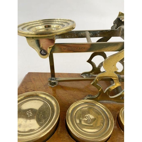 161 - Set of late 19th century Sampson Mordan and Co. postal scales, with seven graduated weights on oak p... 