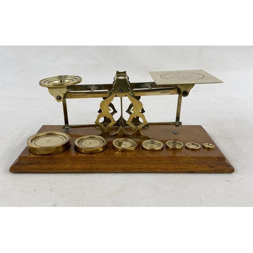 161 - Set of late 19th century Sampson Mordan and Co. postal scales, with seven graduated weights on oak p... 