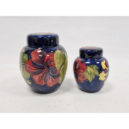 12 - Moorcroft 'Hibiscus' pattern ginger jar, blue ground, signed to base, 20cm high approx. and another ... 