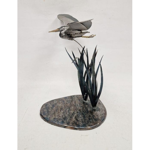 126 - Metal sculpture of a heron flying amidst reeds, 'en tremblant', 58cm high