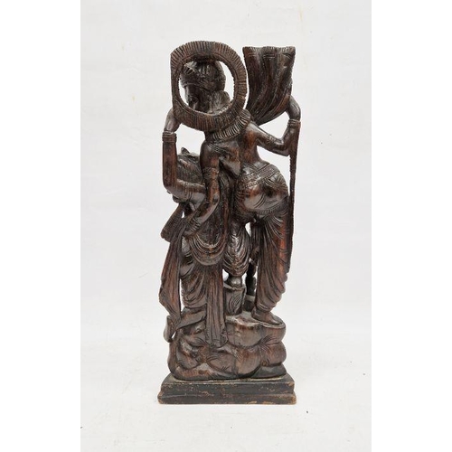 152 - Eastern hardwood carving showing a female figure leaning towards a male figure, 50cm high