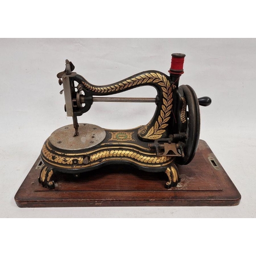 87 - Late 19th century Jones hand sewing machine, decorated throughout with ornate gilt motifs on a black... 