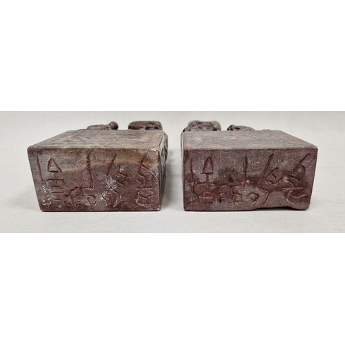 94 - Pair of Chinese carved soapstone figures of dogs of fo, 20th century, on rectangular bases, incised ... 