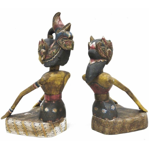 116 - Pair of 20th century carved wooden Asian figures depicting a male and female, each wearing tradition... 