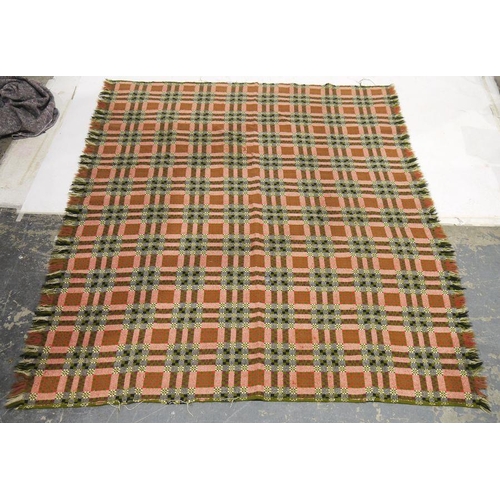 122 - Large Welsh wool blanket decorated with red, black and white geometric decoration, on a green ground... 