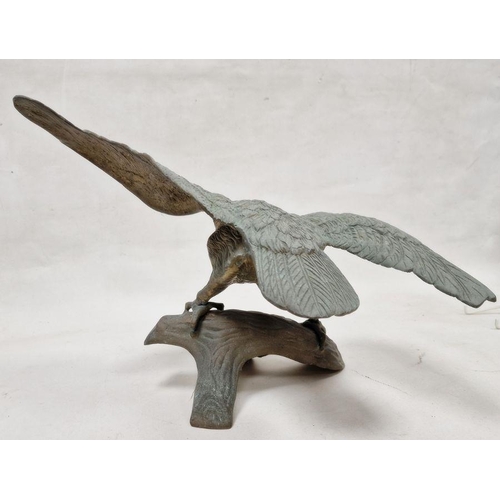 141 - Large metal model depicting eagle perched upon a branch, with wings spread, 32cm high approx.