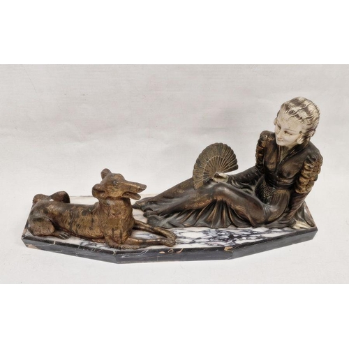 146 - Art Deco figure group depicting a seated lady in period dress, beside a dog, the lady holding a hand... 