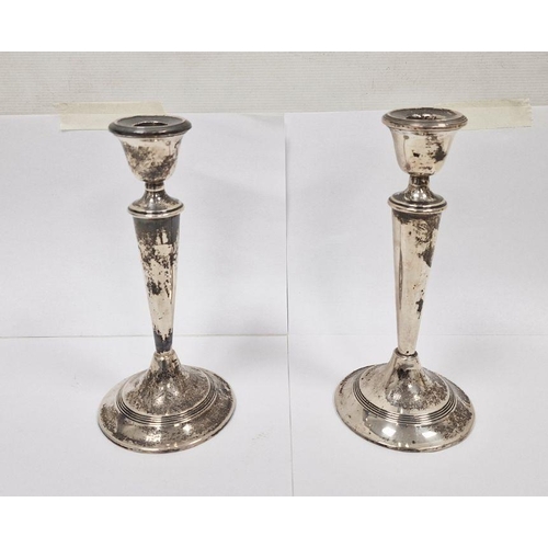 298 - Pair of early 20th century silver-mounted candlesticks, 22cm high