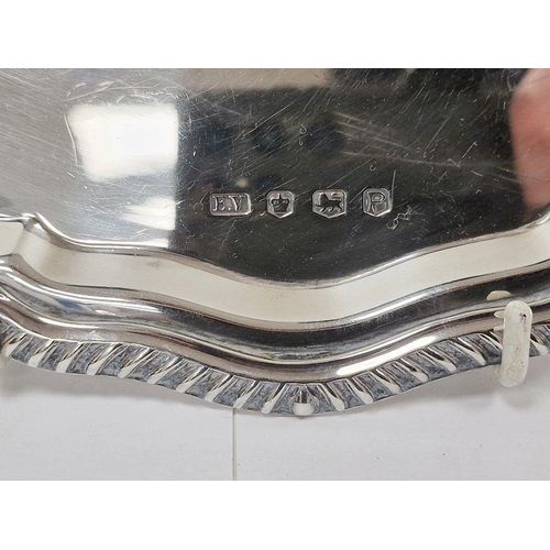 336 - LOT WITHDRAWN
 Silver salver with gadrooned serpentine border, inscription to top, on three scroll s... 