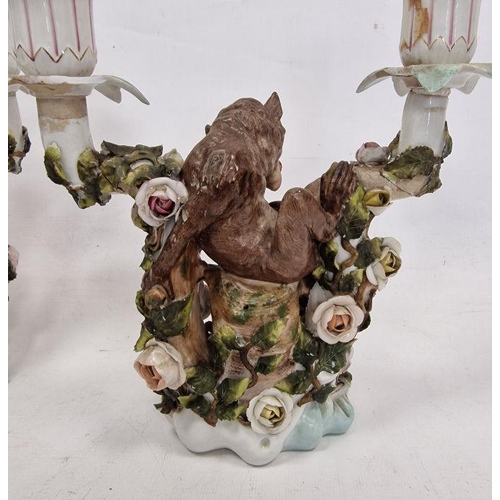 48 - Pair German Plaue porcelain monkey candelabra, each two-branched and floral encrusted with monkeys t... 