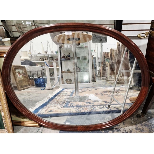 1238 - 20th century mahogany framed wall mirror of oval form, 91cm x 73cm