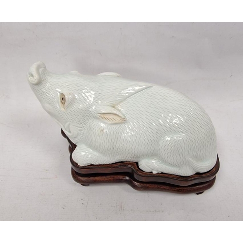 175 - Chinese Export style white glazed porcelain model of a boar on wooden stand, kneeling, in the Qianlo... 