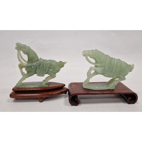 176 - Two various carved jade horses, each with raised foreleg, 9cm high and the hardwood stands (some dam... 