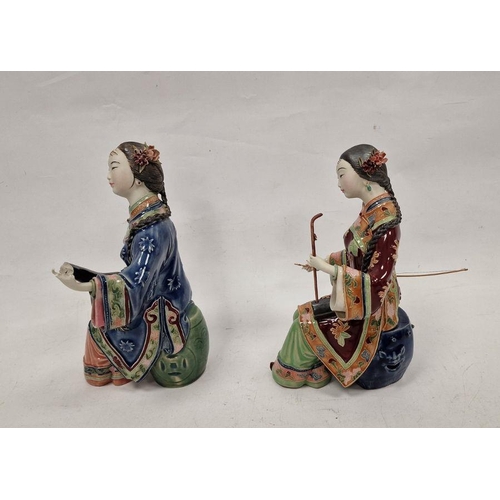 179 - Pair of Japanese figures, seated female musicians, variously in red and blue robes, 26cm high