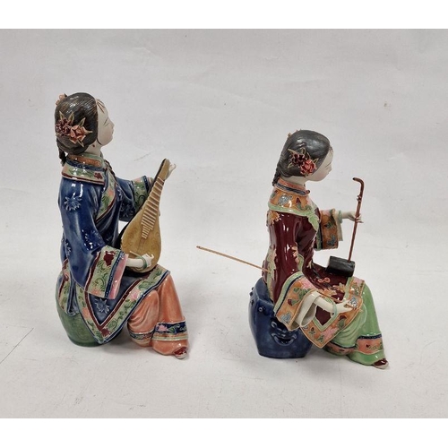 179 - Pair of Japanese figures, seated female musicians, variously in red and blue robes, 26cm high