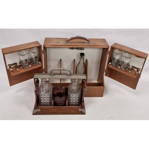 203 - Vintage travelling/picnic drinks cabinet, an oak tantalus with two cut decanters and a stained woode... 