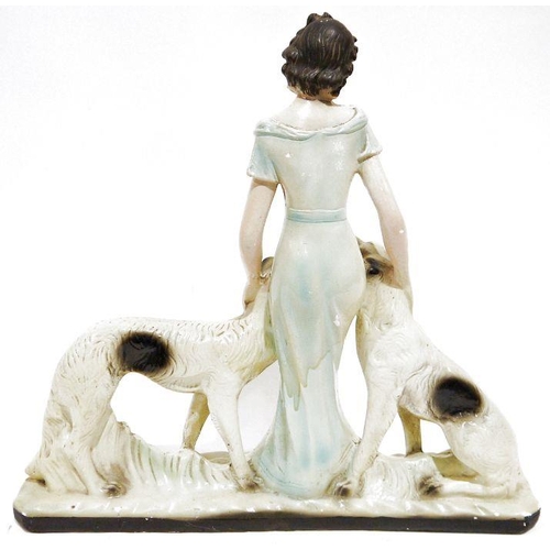 265 - Art Deco painted plaster group of a woman in evening dress with two borzoi hounds, 55cm high