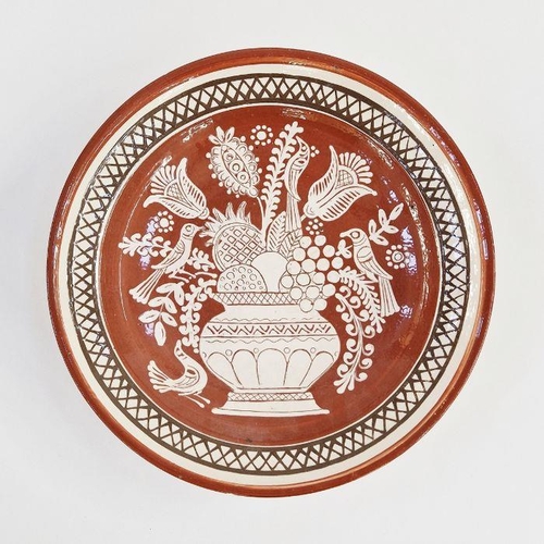 44A - Russel-Tiglia Tegelen (Dutch) large terracotta charger, slip decorated with flowers in a vase and bi... 