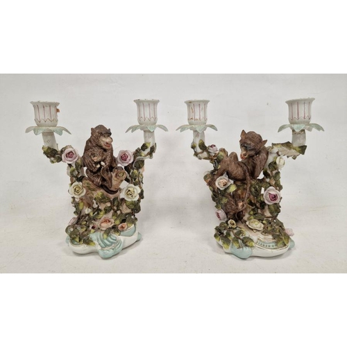 48 - Pair German Plaue porcelain monkey candelabra, each two-branched and floral encrusted with monkeys t... 