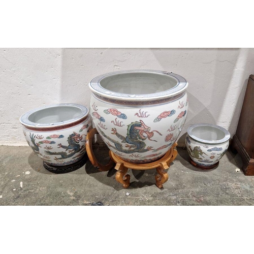 85 - Three modern Chinese porcelain jardinieres or fish bowls, printed and painted with scrolling dragons... 