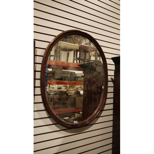 1238 - 20th century mahogany framed wall mirror of oval form, 91cm x 73cm