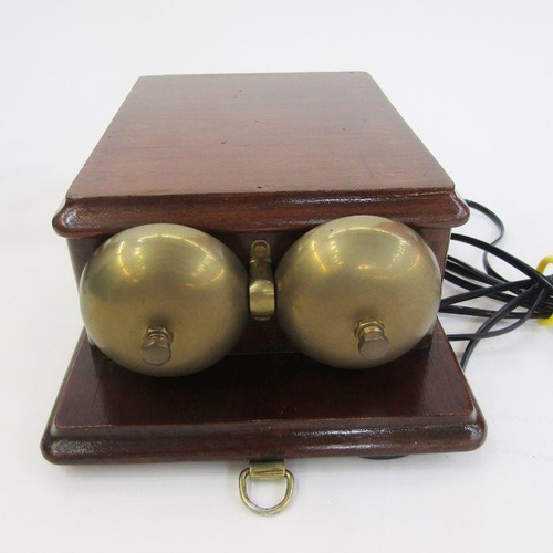 169 - Early 20th century bakelite and brass candlestick telephone with the accompanying bell ringing set, ... 