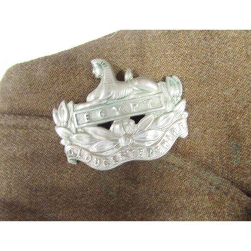 210 - WWII Home Guard battledress jacket with cap and cap badge of the Gloucestershire Regiment, gas mask,... 