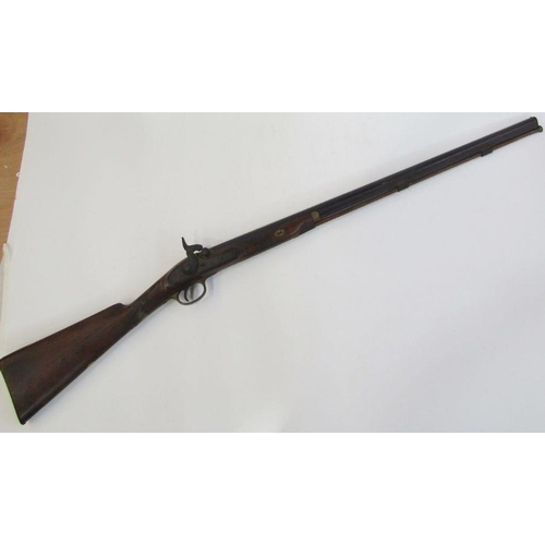 212 - A 19th century percussion rifle with walnut and brass stock, complete with ram-rod.