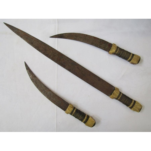 214 - Three early 20th century daggers of Middle Eastern origin.