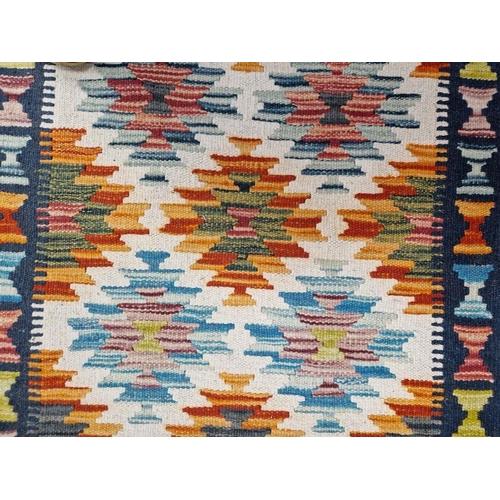 1030 - Cream ground Chobi kilim runner with one row of five geometric medallions flanked by tow rows of six... 